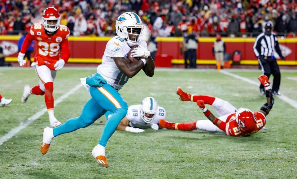 Miami Dolphins wide receiver Tyreek Hill (10) scores in the second quarter against the Kansas City Chiefs at GEHA Field at Arrowhead Stadium in Kansas City, Missouri, on Saturday, Jan. 13, 2024.