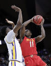 <p>Maryland’s Darryl Morsell (11) takes a shot against LSU’s Kavell Bigby-Williams, left, during the first half of a second-round game in the NCAA men’s college basketball tournament in Jacksonville, Fla., Saturday, March 23, 2019. (AP Photo/John Raoux) </p>