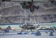 A lander for China's Mars mission is seen before a hovering-and-obstacle avoidance test at a test facility in Huailai