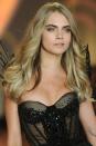 <p>Delevingne wore a soft, smoky eye and perfectly curled waves in 2013.</p>