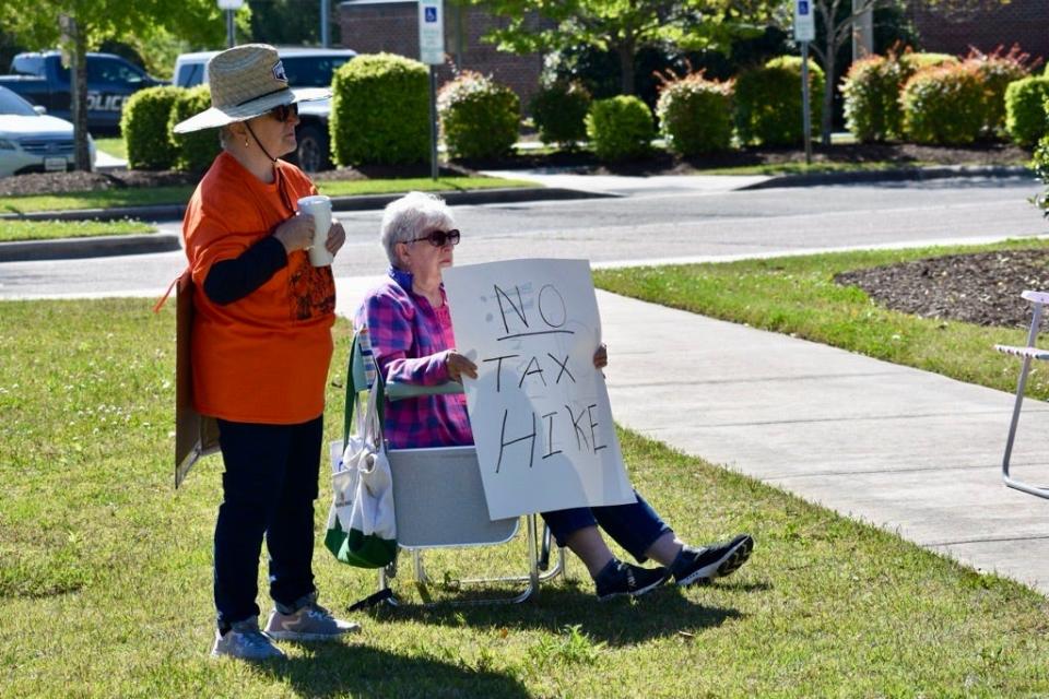 A Leland resident displays a sign demanding "No Tax Hike" on Saturday, April 13, 2024, at a rally against a proposed property tax increase.