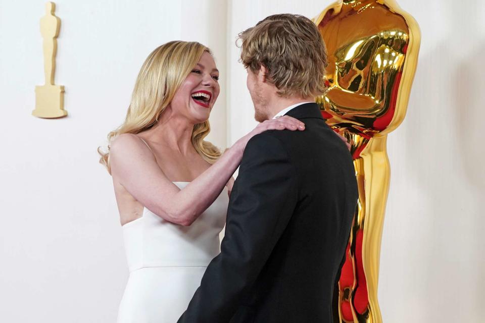 <p>Jordan Strauss/Invision/AP</p> Kirsten Dunst laughs off  trip on 2024 Oscars red carpet with husband Jesse Plemons 