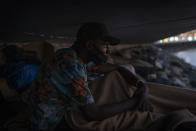 Khalid, a migrant from Gambia, sits on a breakwater under a bridge in Gran Canaria island, Spain, on Saturday, Aug. 22, 2020. More than 250 people are known to have died or gone missing in the Atlantic route so far this year according to the International Organization for Migration. That's already more than the number of people who perished trying to cross the Western Mediterranean in all of last year. (AP Photo/Emilio Morenatti)