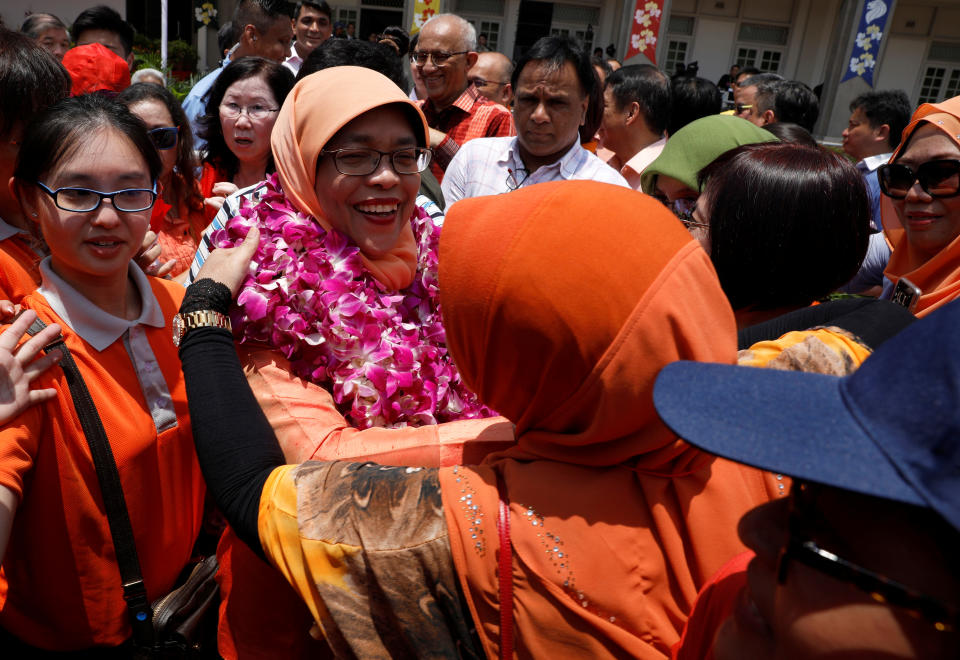 Singapore's president-elect Halimah Yacob greets supporters as she leaves the nomination centre during Nomination Day in 2017.
