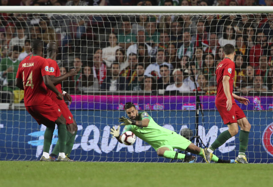 Portugal goalkeeper Rui Patricio makes a save during the Euro 2020 group B qualifying soccer match between Portugal and Serbia at the Luz stadium in Lisbon, Portugal, Monday, March 25, 2019. (AP Photo/Armando Franca)