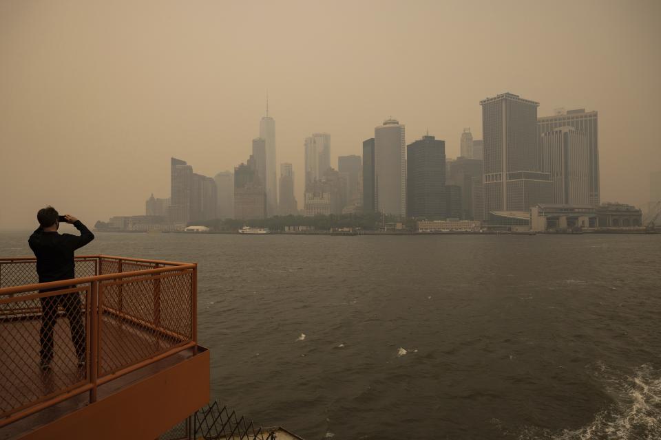 FILE - New York City is visible in a haze-filled sky due to wildfires in Canada, photographed from the Staten Island Ferry, Wednesday, June 7, 2023, in New York. Earth last year shattered global annual heat records, the European climate agency said Tuesday, Jan. 9, 2024. (AP Photo/Yuki Iwamura)