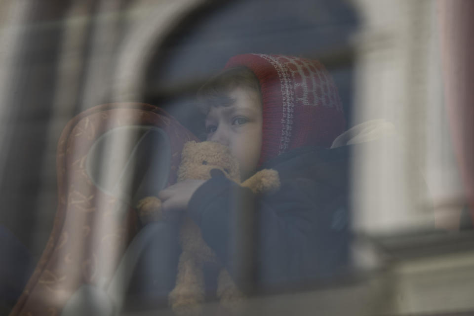 A child who fled the war in Ukraine waits in a bus after arriving to Przemysl train station in Przemysl, Poland, Tuesday, March 15, 2022. (AP Photo/Petros Giannakouris)