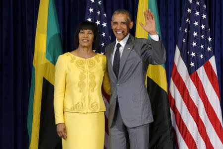 U.S. President Barack Obama stands for a photograph with Jamaica's Prime Minister Portia Simpson Miller upon his arrival at Jamaica House in Kingston April 9, 2015. REUTERS/Jonathan Ernst