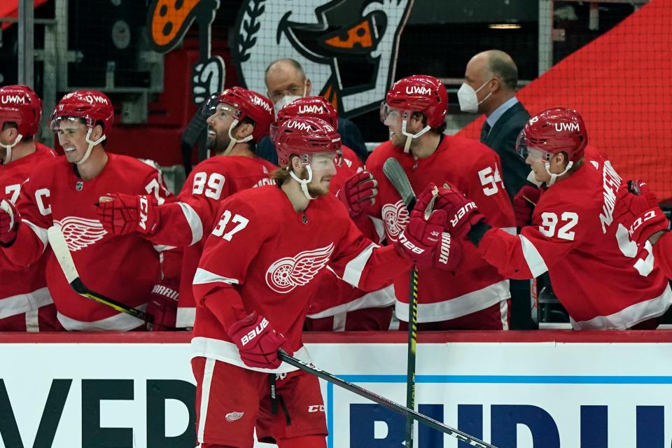 Detroit Red Wings left wing Evgeny Svechnikov greets teammates after scoring during the first period of an NHL hockey game against the Columbus Blue Jackets, Sunday, March 28, 2021, in Detroit.