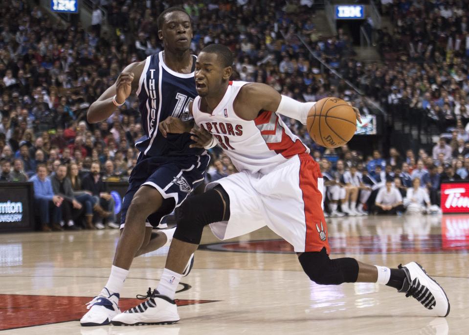 Toronto Raptors forward Terrence Ross, right, drives past Oklahoma Thunder guard Reggie Jackson during the first half of an NBA basketball game in Toronto on Friday, March 21, 2014. (AP Photo/The Canadian Press, Nathan Denette)