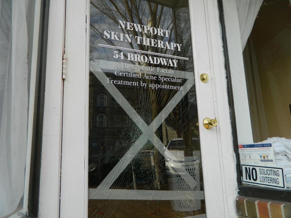 A window is shattered at the entrance to Newport Skin Therapy on Broadway.