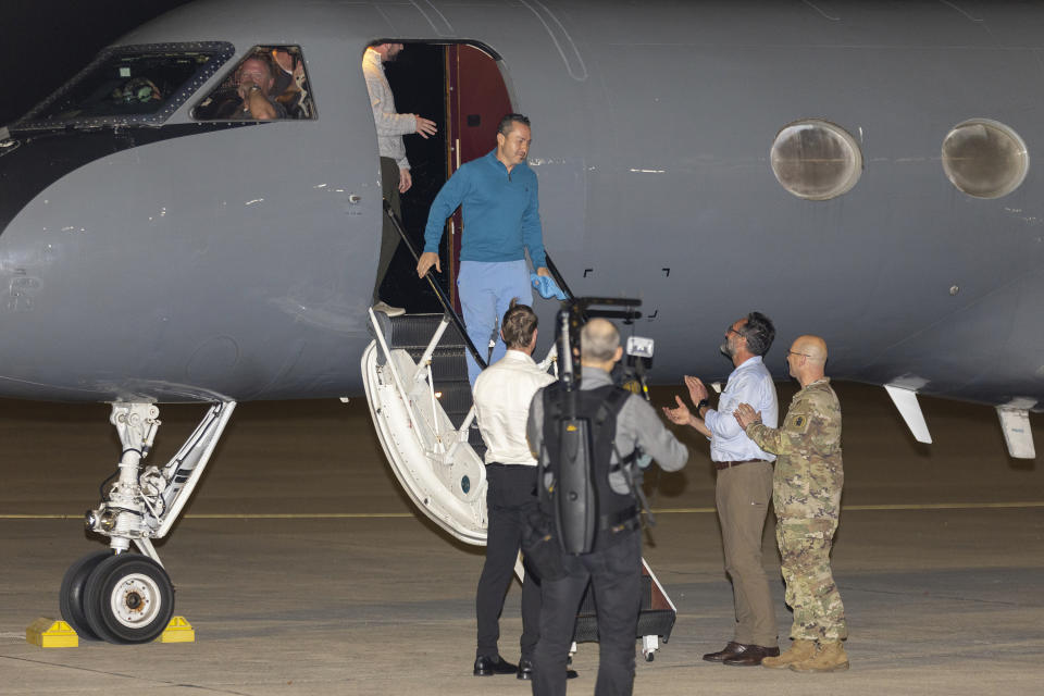 Freed American Eyvin Hernandez exits a State Department plane after he and nine fellow detainees were released in a prisoner swap deal between U.S. and Venezuela at Kelly Airfield Annex, Wednesday, Dec. 20, 2023, in San Antonio, Texas. Six of the Americans released arrived at Kelly Airfield Annex. (AP Photo/Stephen Spillman)