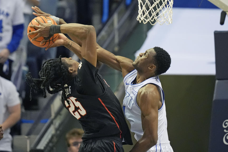 BYU forward Atiki Ally Atiki, right, fouls Houston forward Joseph Tugler (25) during the second half of an NCAA college basketball game Tuesday, Jan. 23, 2024, in Provo, Utah. (AP Photo/Rick Bowmer)