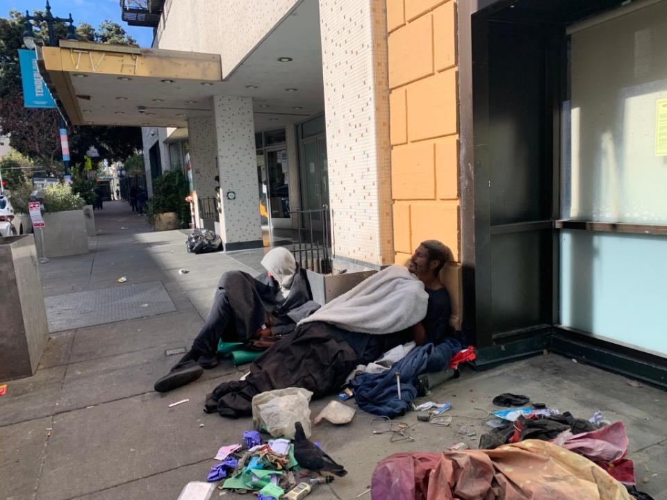 A homeless man sleeps on the street of the Tenderloin District in San Francisco, California on Friday, November 10, 2023. David G. McIntyre