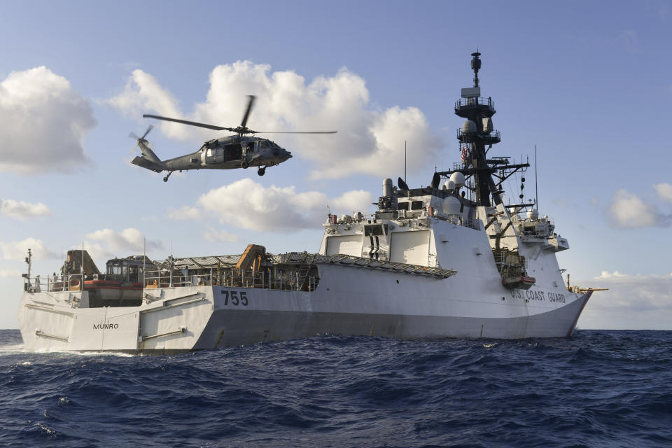 In this Aug. 25, 2020 photo provided by the U.S. Navy, an MH-60S Sea Hawk Helicopter conducts "touch and go" drills aboard the Legend-class cutter USCGC Munro in the Pacific Ocean. The Coast Guard cutter Munro had just embarked on a national security mission to patrol the maritime boarder between the United States and Russia in late June 2020, when one of its guardsman was diagnosed with COVID-19. Contract tracing led to more than a dozen other members of the ship's crew being ordered into quarantine for two weeks. (Mass Communication Specialist 3rd Class Madysson Anne Ritter/U.S. Navy via AP)