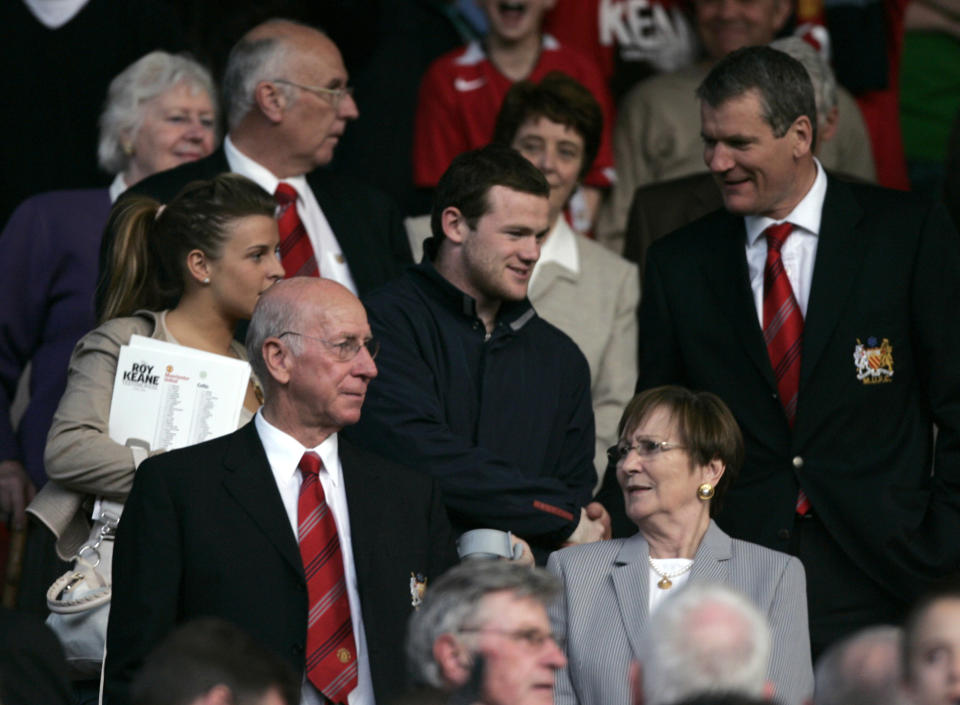 Manchester United and England player Wayne Rooney (C) walks with his girlfriend Coleen McLoughlin (L) to his seat before Roy Keane's testimonial soccer match between Manchester United and Celtic at Old Trafford in Manchester, northern England May 9, 2006.  REUTERS/David Moir