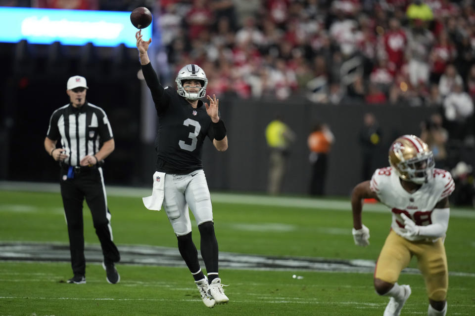 Las Vegas Raiders quarterback Jarrett Stidham throws a 24-yard touchdown pass to tight end Darren Waller during the first half of an NFL football game between the San Francisco 49ers and Las Vegas Raiders, Sunday, Jan. 1, 2023, in Las Vegas. (AP Photo/John Locher)