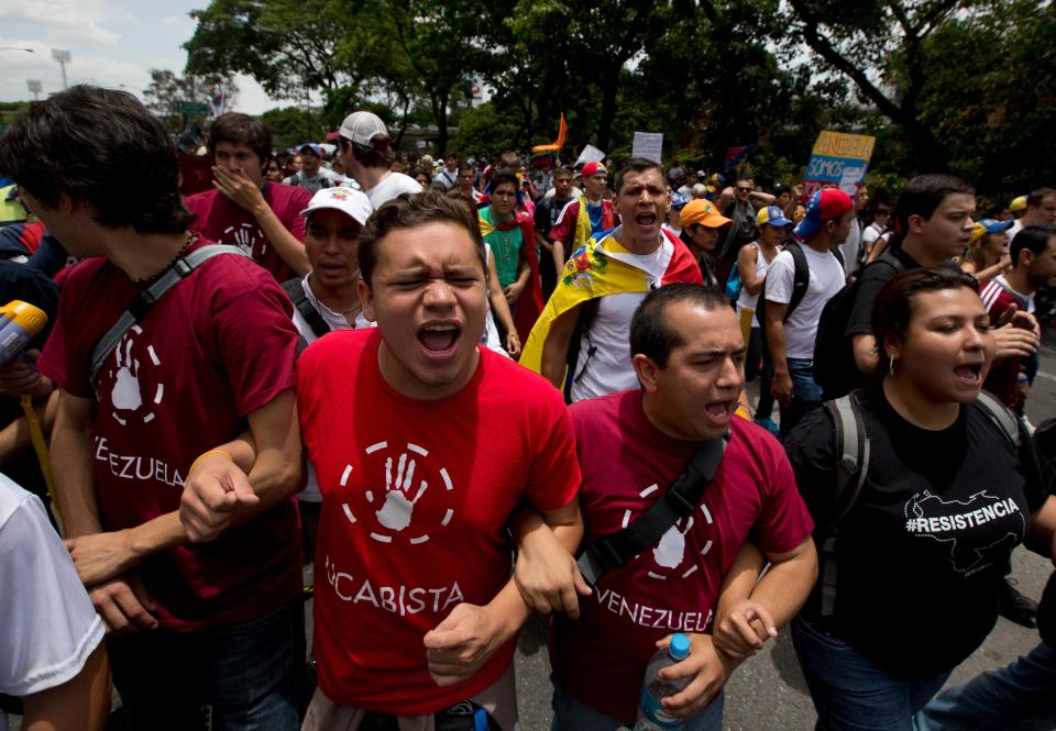 Students shout slogans against Venezuela's President Nicolas Maduro during a protest in Caracas, Venezuela, Saturday, April 26, 2014. Student organizers at the last minute decided against marching downtown to avoid a confrontation with security forces in the government-controlled district. Instead they concentrated in the wealthier, eastern neighborhoods that have been the hotbed of unrest since February. (AP Photo/Fernando Llano)