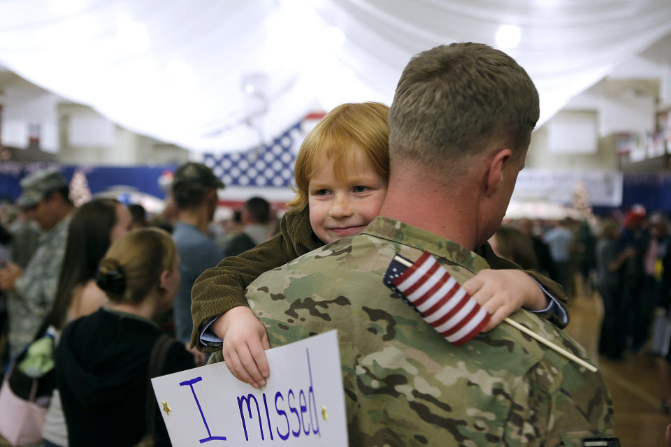 Five-year-old Gavin Shaw flashes a smile as he hugs his father, Master Sgt. Adam Shaw, during a Welcome Home Ceremony for approximately 230 4th Brigade Combat Team soldiers on Nov. 4, 2012, in Fort Carson, Colorado.