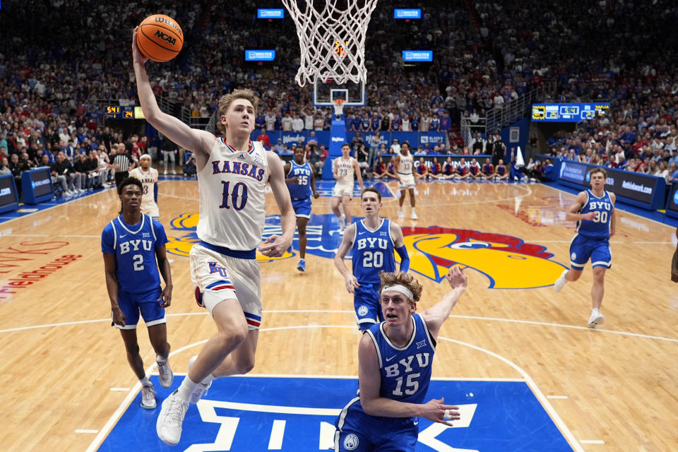 Kansas guard Johnny Furphy (10) dunks the ball during the first half of an NCAA college basketball game against BYU Tuesday, Feb. 27, 2024, in Lawrence, Kan. (AP Photo/Charlie Riedel)