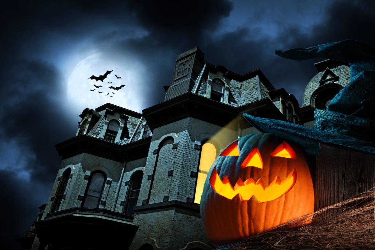 pumpkin in front of spooky house