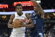 Detroit Pistons center Jalen Duren handles the ball against Memphis Grizzlies center Trey Jemison (55) in the first half of an NBA basketball game Friday, April 5, 2024, in Memphis, Tenn. (AP Photo/Brandon Dill)