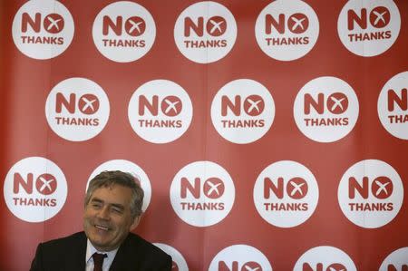 Former British Prime Minister Gordon Brown listens to a speaker before making a speech about pensions at a "Better Together" rally in Kilmarnock, Scotland September 11, 2014.REUTERS/Paul Hackett