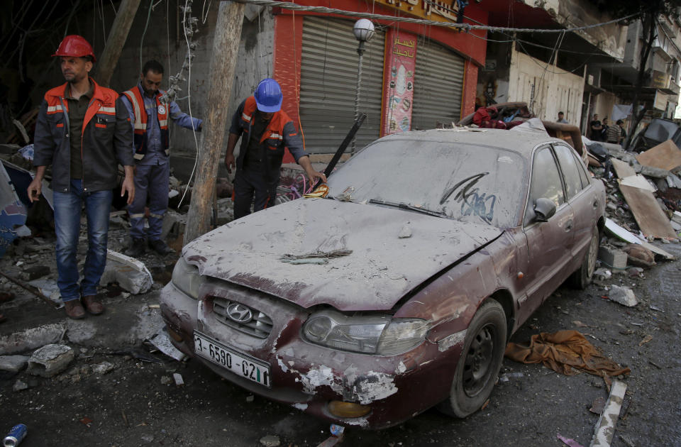 Palestinians inspect the damage from an early morning Israeli airstrike, in Gaza City, Wednesday, May 19, 2021. (AP Photo/Hatem Moussa)