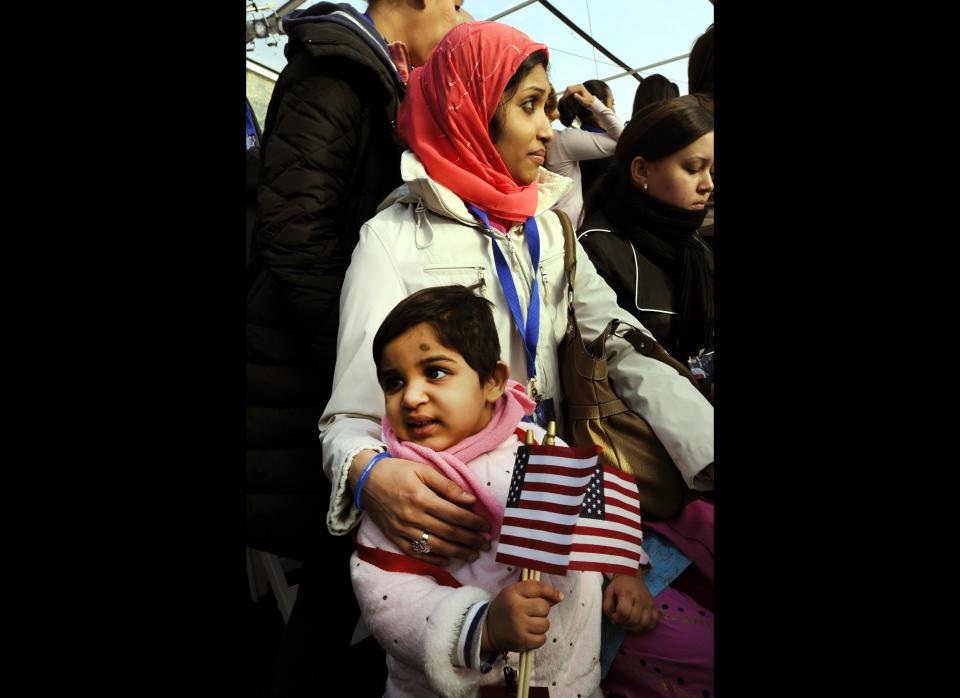 Fahmida Islam and Faiza Islam, age 2 from Bangladesh, pose after  being sworn in during a naturalization ceremony conducted to swear in 125 new citizenship candidates at a ceremony on Liberty Island October 28,2011 in New York, to commemorate the 125th anniversary of the dedication of the Statue of Liberty.  AFP PHOTO / TIMOTHY A. CLARY (Photo credit should read TIMOTHY A. CLARY/AFP/Getty Images)