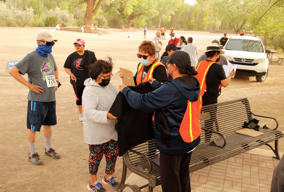 Just Move It participants pick up their T-shirts on May 11 at Berg Park in Farmington.