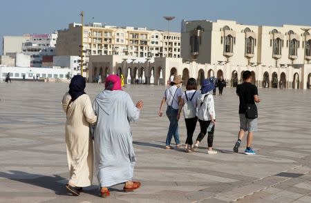 Chinese tourists walk on the esplanade of the Hassan II Mosque in Casablanca, October 6, 2016. REUTERS/Youssef Boudlal