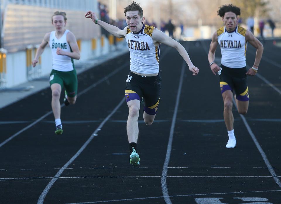 Nevada's Connor Kunze finishes the 100-meter dash at the Nevada Invitational boys track meet at Cub Stadium on Tuesday, March 28, 2023, in Nevada, Iowa.