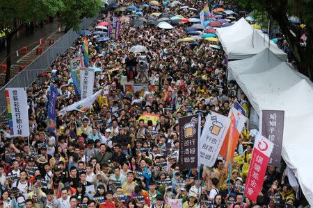 Same-sex marriage supporters hold umbrellas and rainbow flags as they take part in a rally during a parliament vote on three different draft bills of a same-sex marriage law, outside the Legislative Yuan in Taipei, Taiwan May 17, 2019. REUTERS/Tyrone Siu