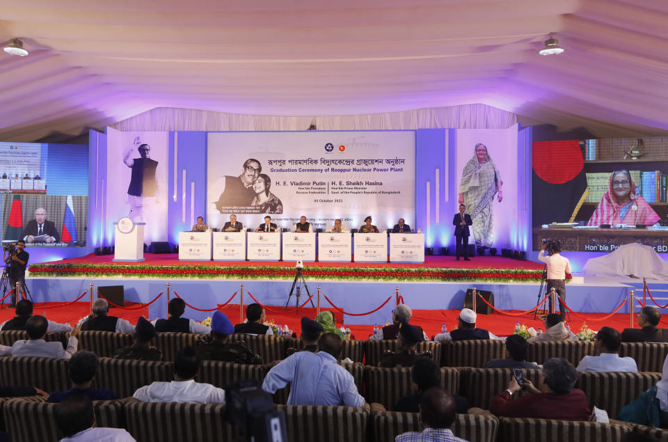 Russian President Vladimir Putin, screen on left and Bangladeshi Prime Minister Sheikh Hasina, screen on right, attend through video conferencing the fuel handover ceremony of the Rooppur Nuclear Power Plant at Ishwardi in Pabna, Bangladesh, Thursday, Oct.5, 2023. (AP Photo/Mahmud Hossain Opu)