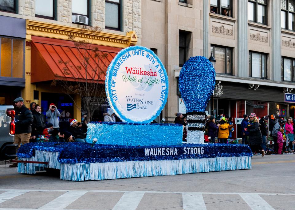 A parade float in remembrance of those who passed away leads the Waukesha Christmas Parade on Sunday December 4, 2022 in Waukesha, Wis.