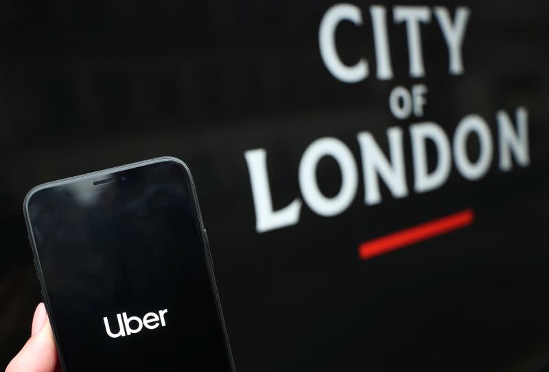 The Uber logo is displayed on a mobile phone in this picture illustration