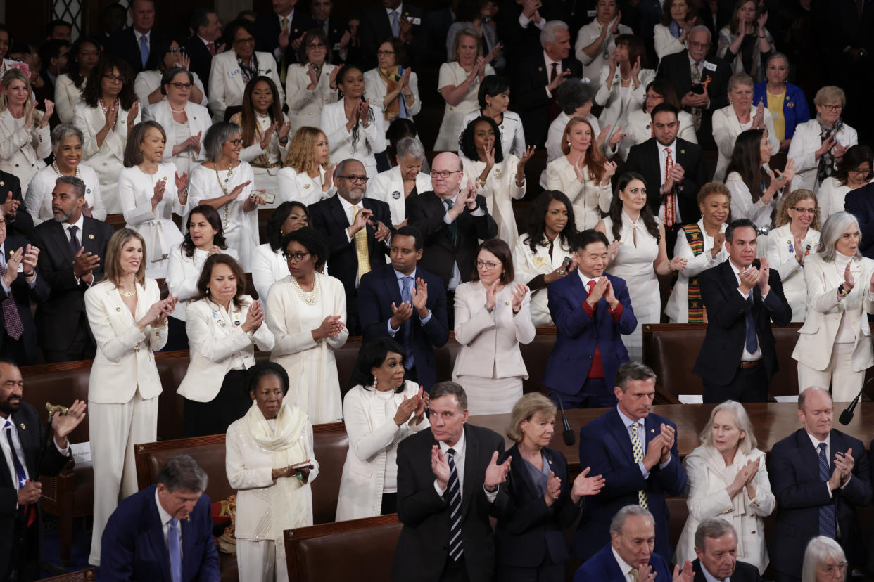 Members of the Democratic Women's Caucus wear white for woman's rights at the State of the Union address