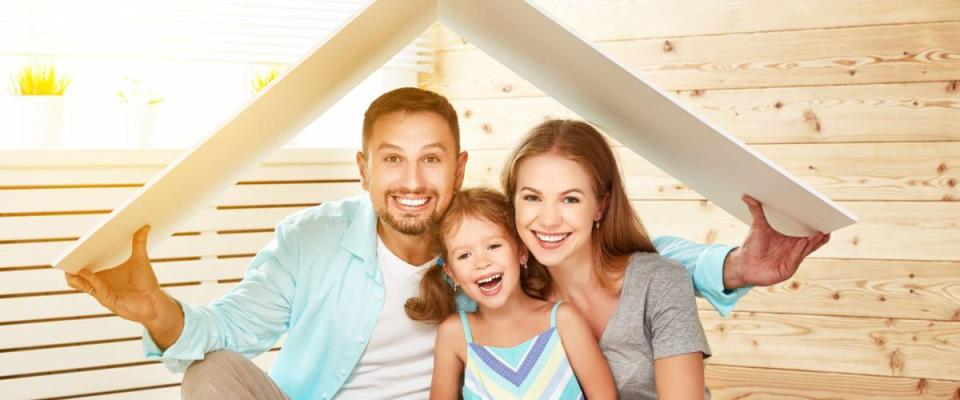 concept housing a young family. Mother father and child in new house with a roof