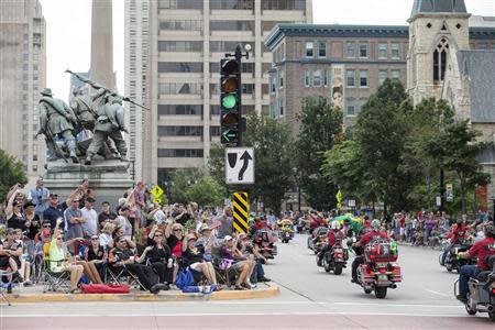 Spectators line the street as Harley riders participate during the the Harley Davidson 110th Anniversary Celebration parade in Wisconsin Avenue, Milwaukee August 31, 2013. REUTERS/Sara Stathas