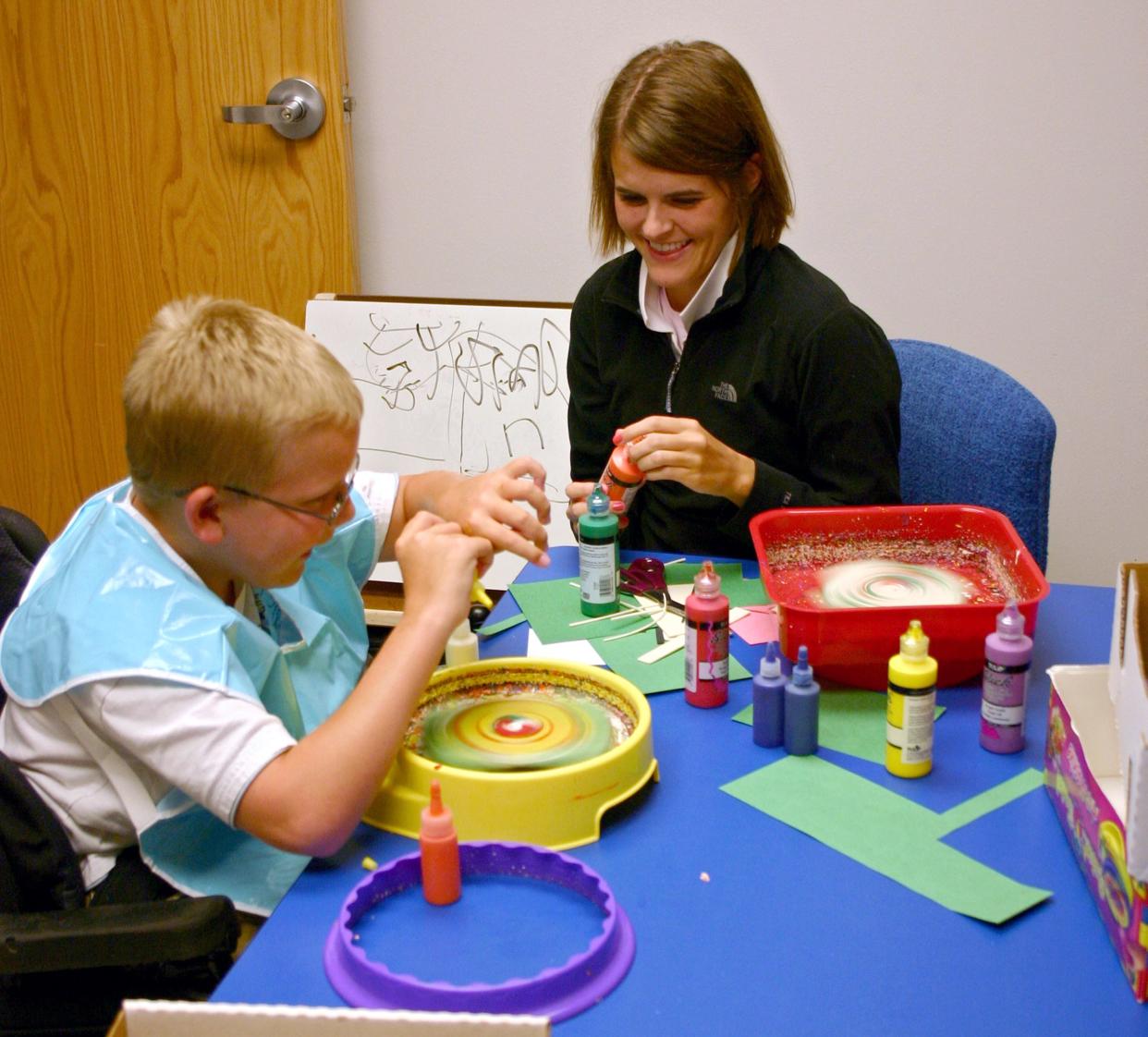 Whitney Grigsby, a doctoral student in occupational therapy from Creighton University, is working with J.D. McCarty Center patient Dalton Blevens. Blevens was just one of the patients that Grigsby worked with during her 12-week pediatric clinical rotation at the pediatric rehab specialty hospital in Norman that specializes in children with developmental disabilities.