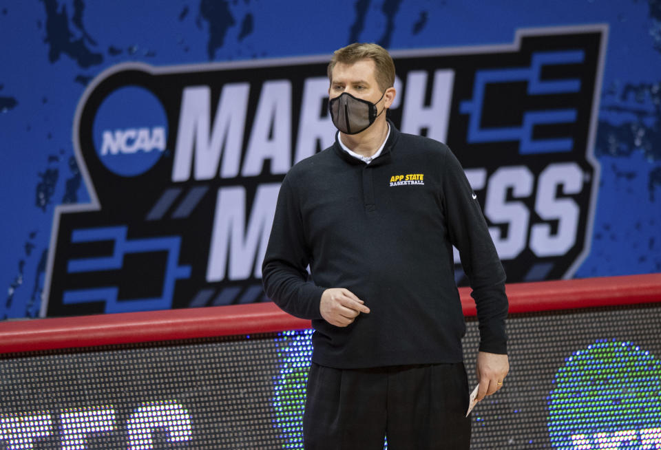 Appalachian State head coach Dustin Kerns watches the action on the court during the first half of a First Four game against Norfolk State in the NCAA men's college basketball tournament, Thursday, March 18, 2021, in Bloomington, Ind. (AP Photo/Doug McSchooler)