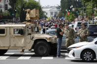 A checkpoint blocks traffic on 16th Street Northwest as people gather near the White House, Saturday, June 6, 2020, in Washington, before scheduled protests over the death of George Floyd, who died after being restrained by Minneapolis police officers. (AP Photo/Patrick Semansky)