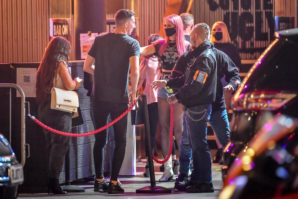 Young people queue to get into a pub in Cardiff city centre: PA