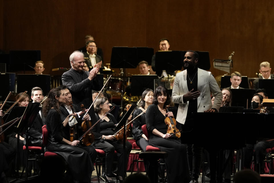 Music Director of the National Symphony Orchestra (NSO) Gianandrea Noseda, left, and Composer Carlos Simon smile as they accept applause during a concert at Milan's La Scala theatre, Italy, Monday, Feb. 26, 2024. (AP Photo/Antonio Calanni)