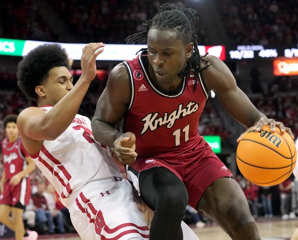 Wisconsin guard Chucky Hepburn fouls Rutgers center Clifford Omoruyi (11) during the first half Saturday at the Kohl Center in Madison.