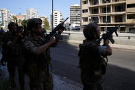 Lebanese army soldiers deploy during armed clashes that erupted during a protest in the southern Beirut suburb of Dahiyeh, Lebanon, Thursday, Oct. 14, 2021. It was not immediately clear what triggered the gunfire, but tensions were high along a former civil war front-line between Muslim Shiite and Christian areas. (AP Photo/Hassan Ammar)