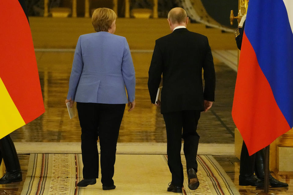 Russian President Vladimir Putin, right, and German Chancellor Angela Merkel leave a joint news conference following their talks in the Kremlin in Moscow, Russia, Friday, Aug. 20, 2021. The talks between Merkel and Putin are expected to focus on Afghanistan, the Ukrainian crisis and the situation in Belarus among other issues. (AP Photo/Alexander Zemlianichenko, Pool)