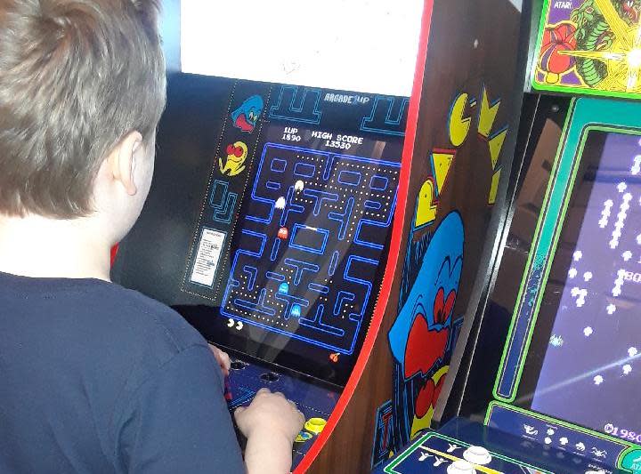 Lucas, 9-years-old, trying out Pac-Man on a Arcade1Up cabinet. 