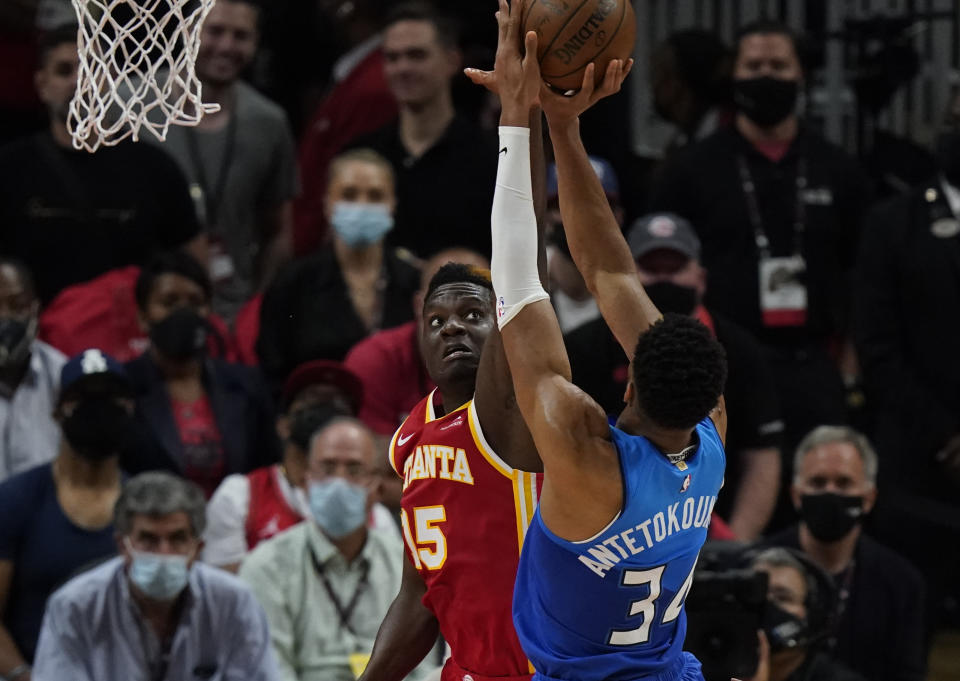 Atlanta Hawks' Clint Capela (15) attempts to block the ball against Milwaukee Bucks' Giannis Antetokounmpo (34) during the first half of Game 3 of the NBA Eastern Conference basketball finals Sunday, June 27, 2021, in Atlanta. (AP Photo/Brynn Anderson)