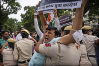 A policeman detains an Indian Youth Congress member during a protest where he along with others held a protest to mark Indian Prime Minister Narendra Modi's birthday in New Delhi, India, Friday, Sept.17, 2021. Youth members of main opposition Congress party clashed with police during a street protest Friday demanding jobs as the country’s economy recovered from the impact of the COVID-19 pandemic that triggered massive unemployment in the country. The march took place as supporters of Prime Minister Narendra Modi celebrated his birthday as he turned 71 on Friday. (AP Photo/Manish Swarup)